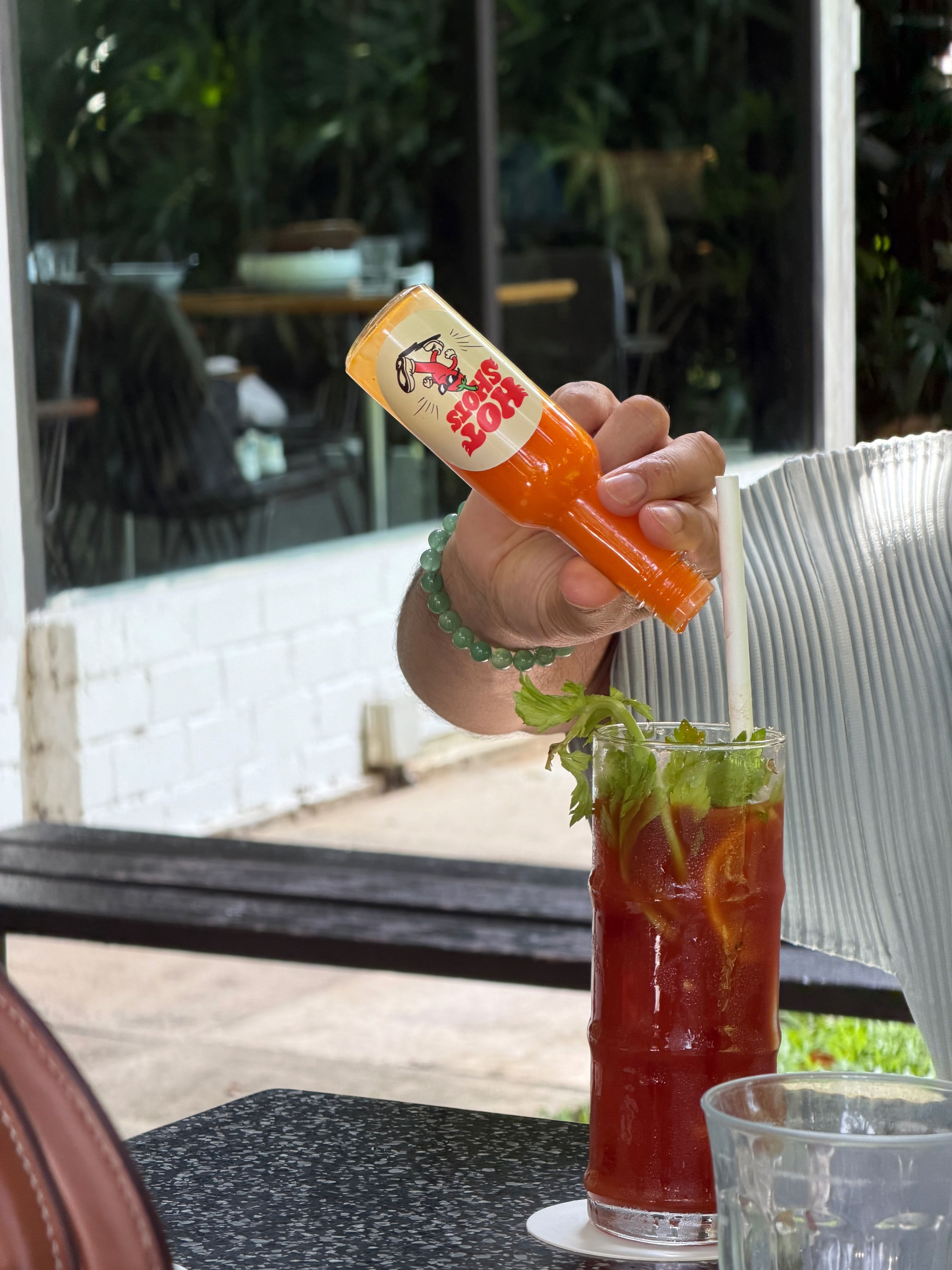 Hot Shots Padi Punch being poured into a Bloody Mary at an outdoor table