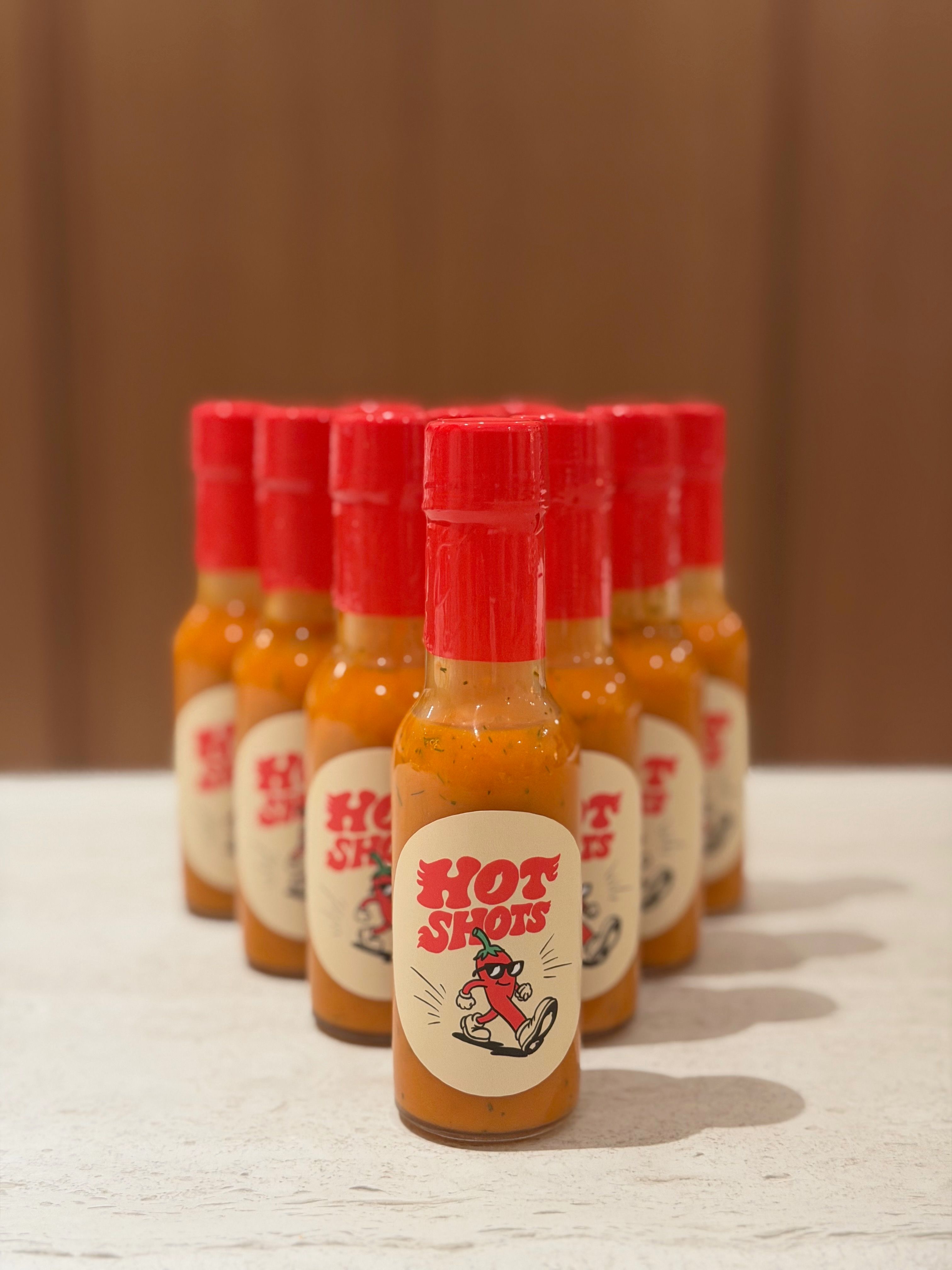 Multiple bottles of Hot Shots Padi Punch arranged in a pyramid stack